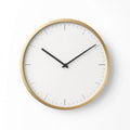 Minimalist gold wall clock on white wall